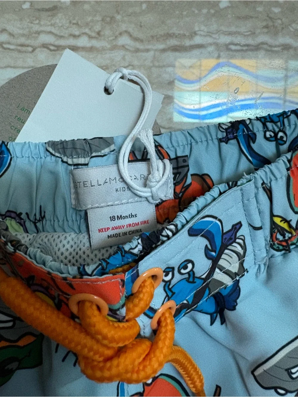 Stella McCartney Kids Light Blue Crab Print Swim Shorts with Orange Drawstring